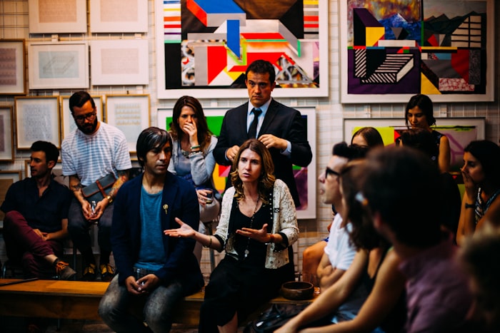 A group standing in animated discussion at a community gathering